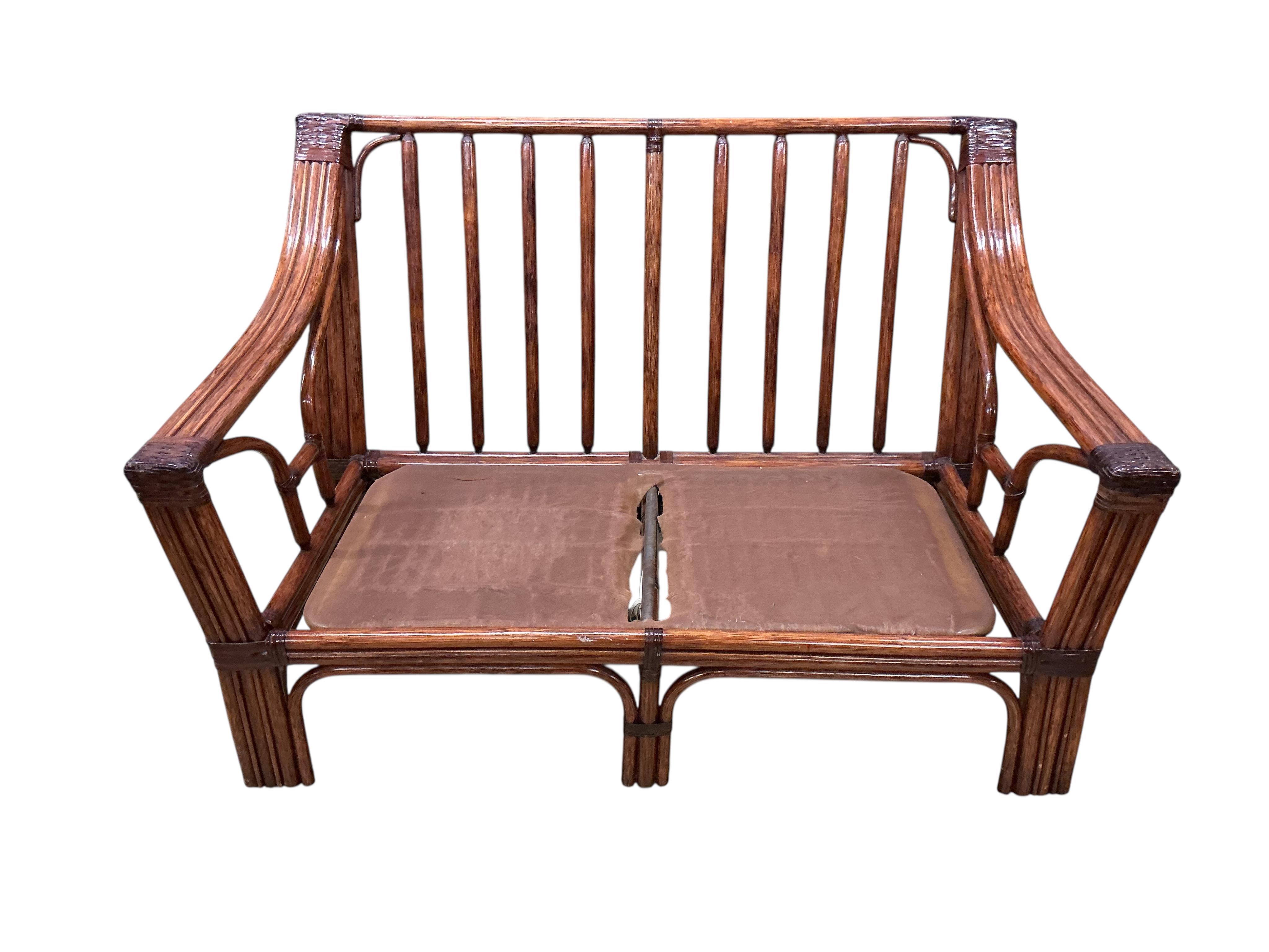 A mid century Roche Bobois faux bamboo three piece suite, lacking some cushions
